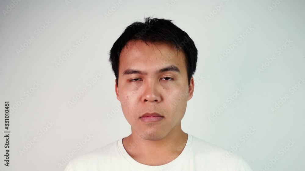 Close up portrait of tired Asian man expressing drowsy and yawn over grey background. Emotion and expression concepts. Close up portrait of tired Asian man expressing drowsy and yawn over grey background. Emotion and expression concepts.