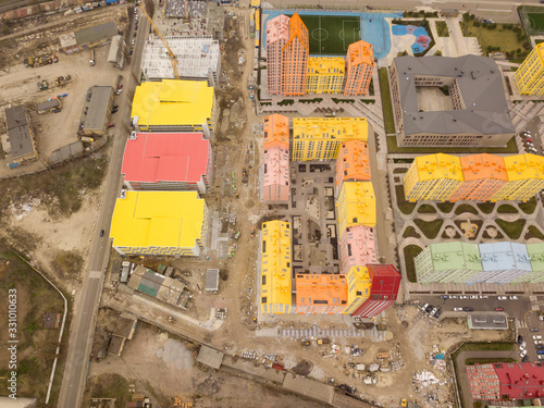 Colorful houses in Comfort Town district in Kyiv at cloudy weather, multi-floor apartment buildings complex. Aerial panoramic drone photo, 17 March 2020. © Sergey