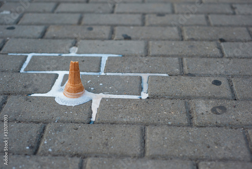 Melting ice cream cornet dropped on the street