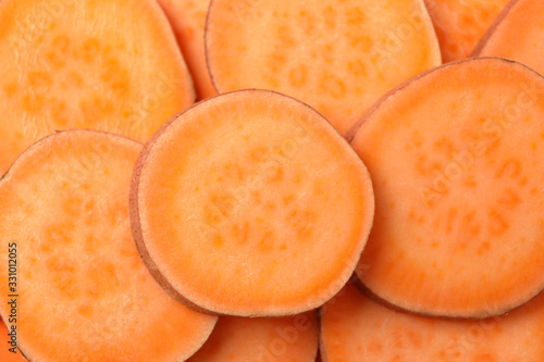 Sweet potato slices on whole background, close up. Vegetables