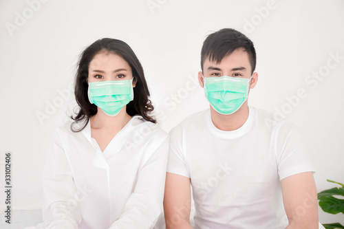 asian love couple wear surgical mask prevent the flu