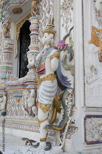 Detail, statue of Wat Pariwat (Beckham's temple) in Bangkok city, Thailand. Religious traditional national Thai architecture. Landmark, sight, architectural monument of Bangkok, Thailand. Asian temple photo