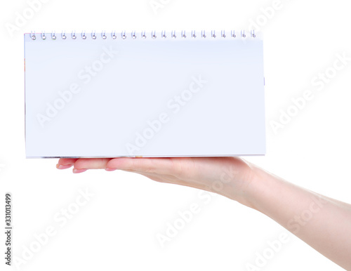 Hand holding empty white calendar with copy space for text on white background isolation