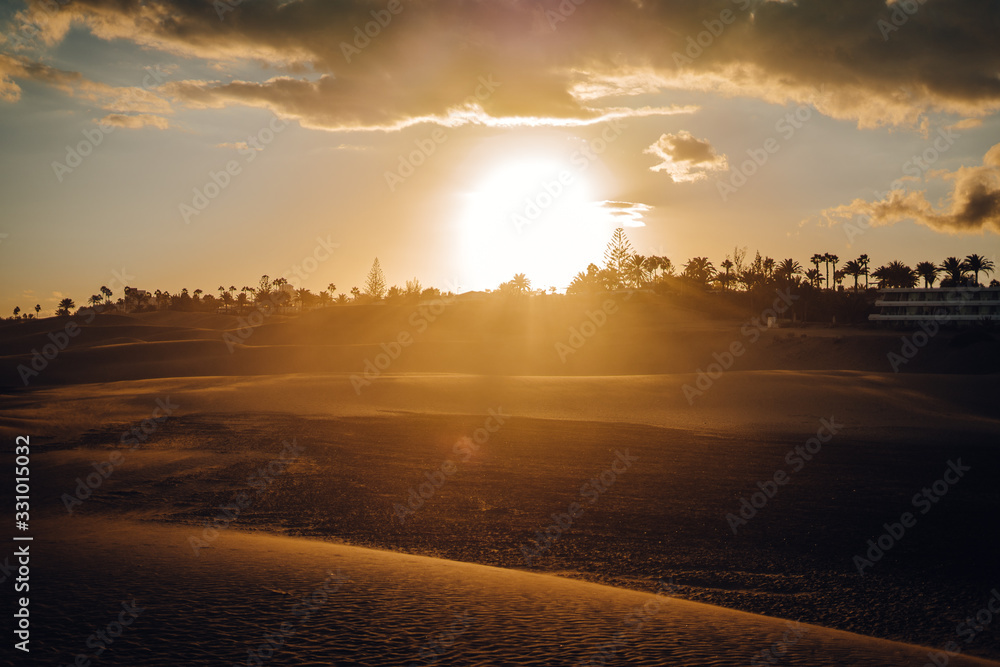 Maspalomas, Canary Islands. Desert dunes at sunset with very orange tones Maspalomas, Canary Islands. Desert dunes at sunset with very orange tones