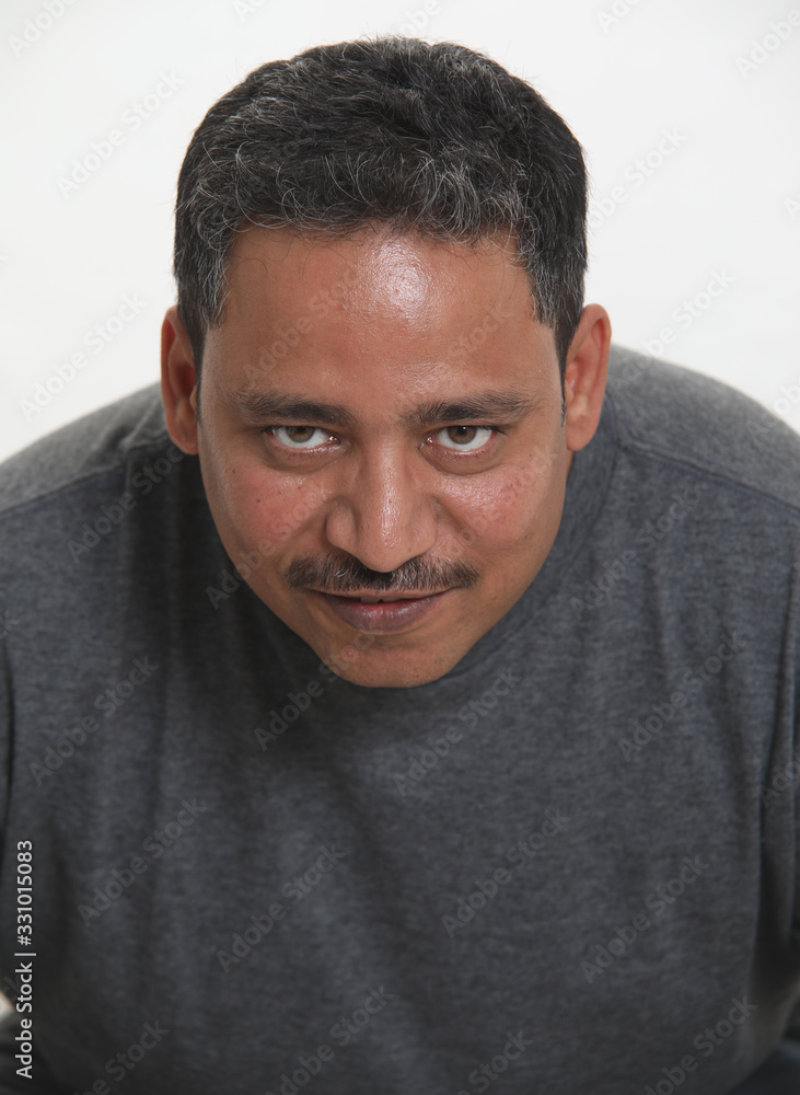 An Indian man in a studio against a white background An Indian man in a studio against a white background