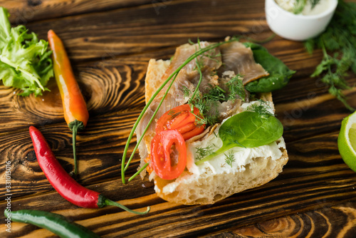 Fresh bread, fish and vegetables sandwiches. Food background, ingredients on the table. Healthy food, styling, cooking concept.