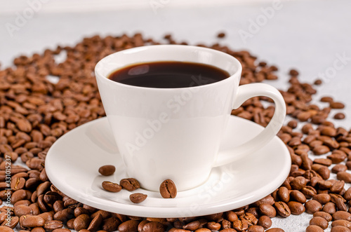 Coffee in a cup with coffee grains