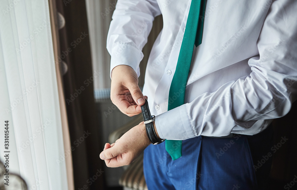 businessman checking time on his wrist watch, man putting clock on hand,groom getting ready in the morning before wedding ceremony. Men Fashion businessman checking time on his wrist watch, man putting clock on hand,groom getting ready in the morning before wedding ceremony. Men Fashion