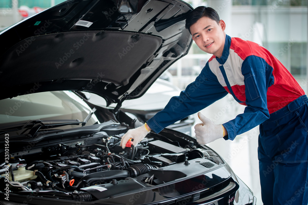 Asian car mechanic in an auto repair shop is checking the engine. For customers who use cars for repair services, the mechanic will work in the garage. Asian car mechanic in an auto repair shop is checking the engine. For customers who use cars for repair services, the mechanic will work in the garage.