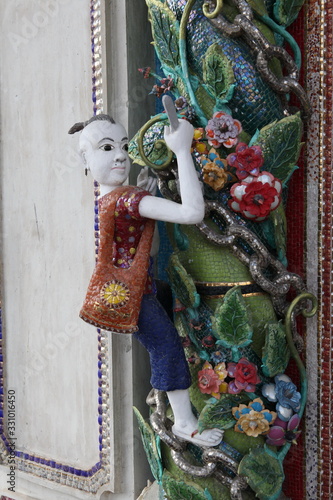 Detail, statue of Wat Pariwat (Beckham's temple) in Bangkok city, Thailand. Religious traditional national Thai architecture. Landmark, sight, architectural monument of Bangkok, Thailand. Asian temple photo