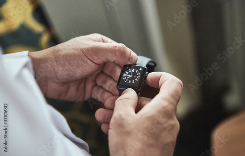 businessman checking time on his wrist watch, man putting clock on hand,groom getting ready in the morning before wedding ceremony. Men Fashion
