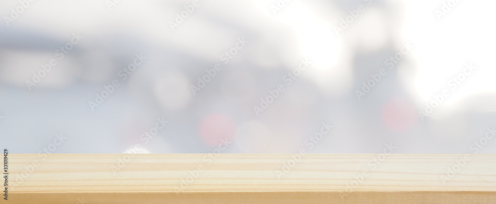 Plakat wood plank table top on blur and bokeh abstract gray and white tone using for banner design and background or shelf display product layout, landscape shot photo.