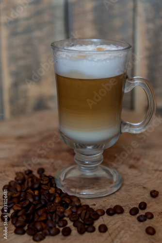 Cappuccino in a glass mug. Beautiful coffee with foam. Latte