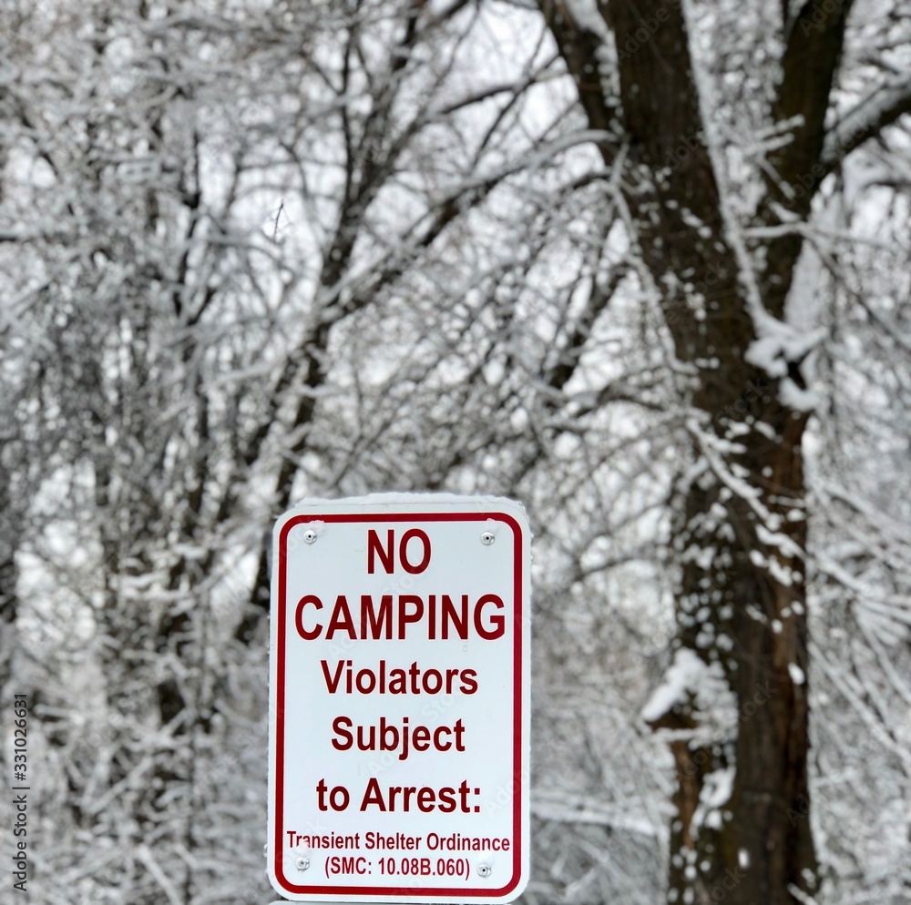 No camping - violators subject to arrest sign posted - scenic winter view in background