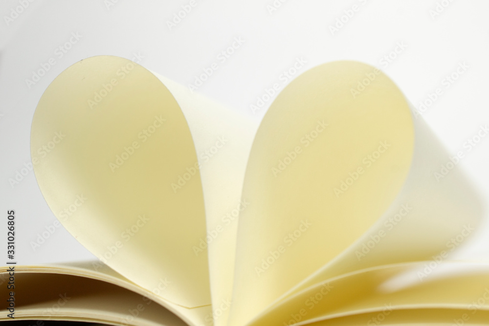 Two blank diary pages that becomes one heart shape. Clean photo of notebook on white background, as concept for valentines day, love stories etc. Two blank diary pages that becomes one heart shape. Clean photo of notebook on white background, as concept for valentines day, love stories etc.