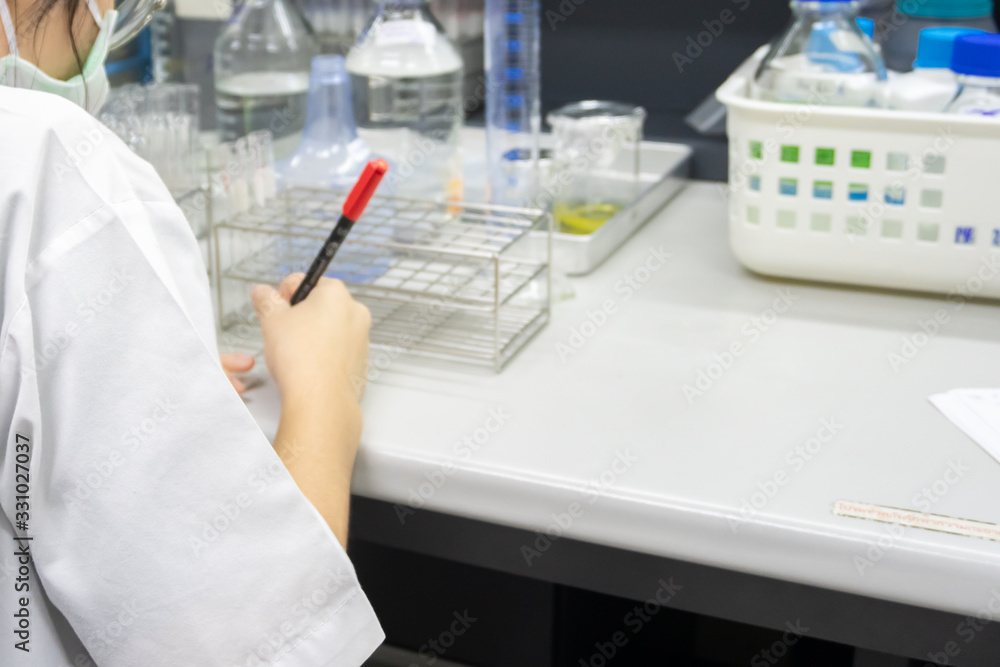 Fototapeta premium Scientist holding Test tube with blood sample for COVID-19 test,Experiment to detect virus was found in the blood,Developers of potential medicines and vaccines against COVID-19
