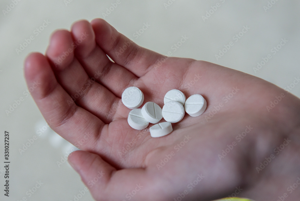 Medication pills or capsules in the hand, palm or fingers. A prescription for the treatment of drugs. Pharmaceuticals, treatment for health. Close-up antibiotic painkiller. Health and medicine concept Medication pills or capsules in the hand, palm or fingers. A prescription for the treatment of drugs. Pharmaceuticals, treatment for health. Close-up antibiotic painkiller. Health and medicine concept