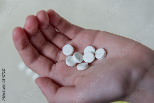 Medication pills or capsules in the hand, palm or fingers. A prescription for the treatment of drugs. Pharmaceuticals, treatment for health. Close-up antibiotic painkiller. Health and medicine concept