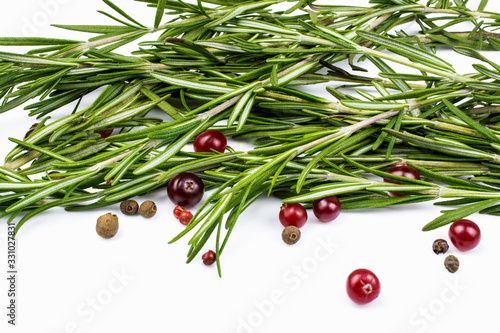 Rosemary, allspice and cranberries isolated on a white background.