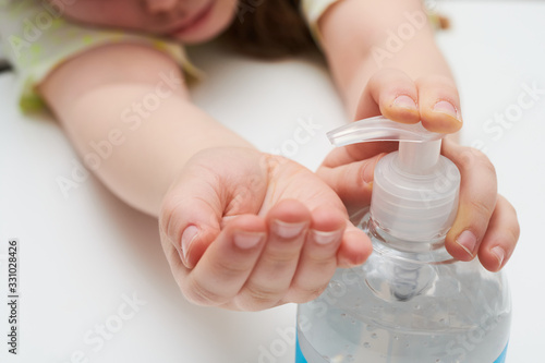 Child using pump bottle antibacterial gel close up