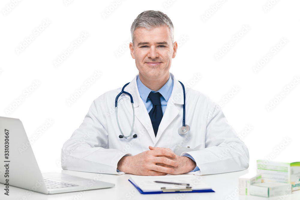 Successful confident doctor seated at a desk Successful confident doctor seated at a desk