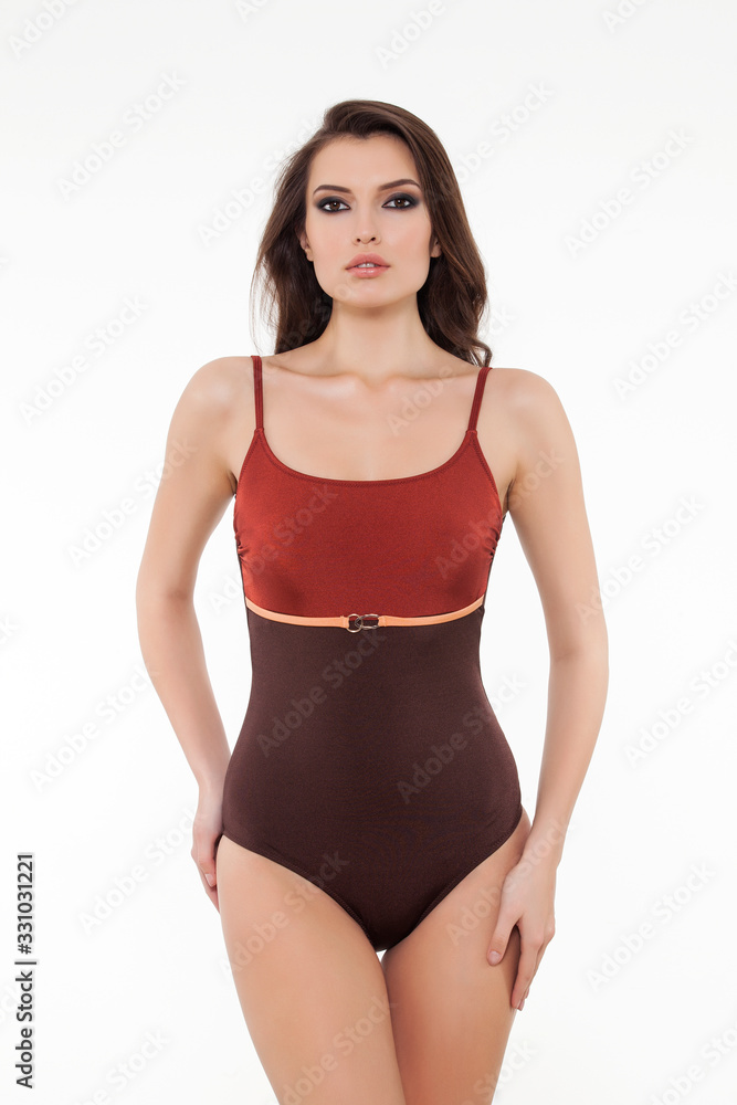 beautiful girl posing in stylish designed chic swimsuit on white background. beautiful girl posing in stylish designed chic swimsuit on white background.