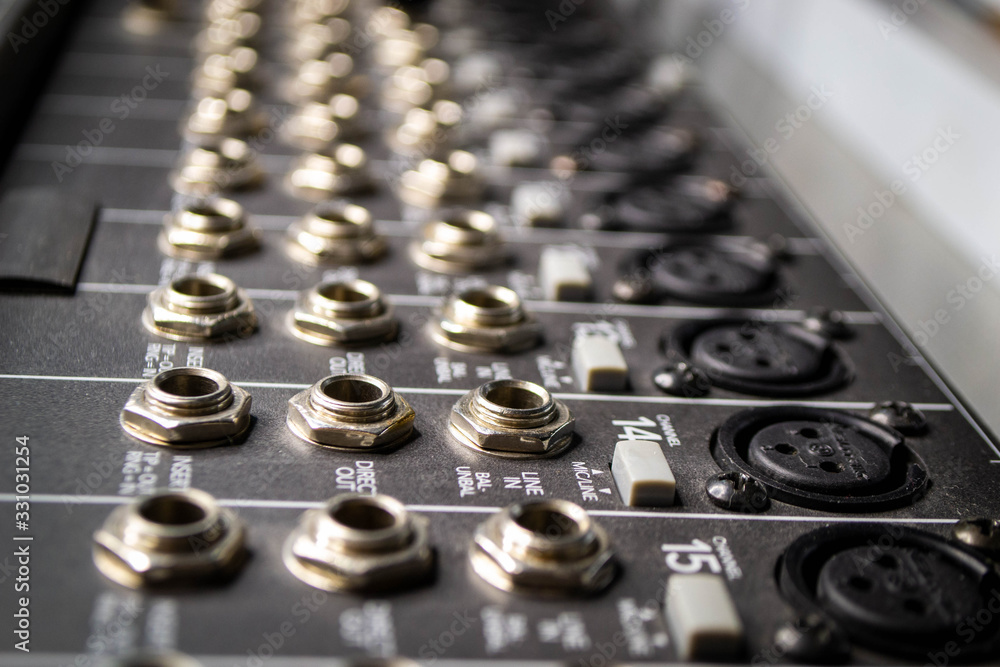 Music mixer in studio closeup. Shot of rotary switch and jack connector in audio board concerte equipment. Music mixer in studio closeup. Shot of rotary switch and jack connector in audio board concerte equipment.