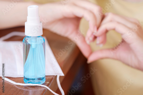 Women her hands and blue alcohol gel bottles for cleaning and medical surgical masks. remove and kill bacteria, germ and virus to avoid contaminating Wuhan coronavirus and epidemic virus symptoms.