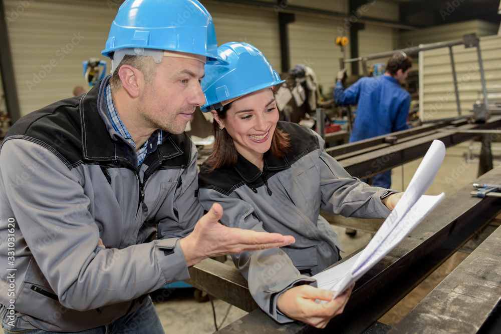 Female worker finds funny his colleague's idea Female worker finds funny his colleague's idea