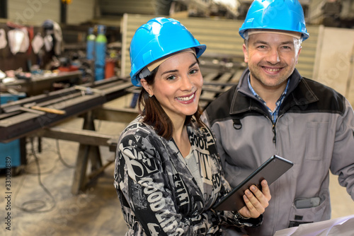 Portrait of happy female manager and male worker smiling at the