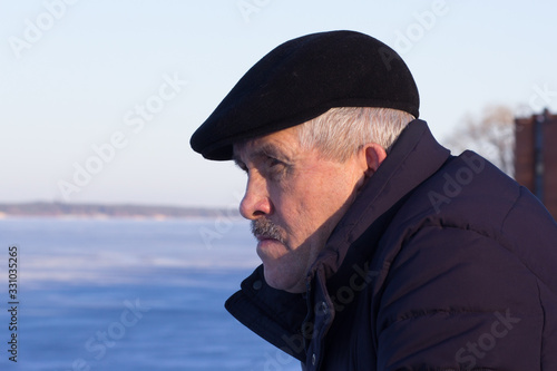 Portrait of serious thoughtful and frowning aged man looking aside in wintertime © Tatiana Foxy
