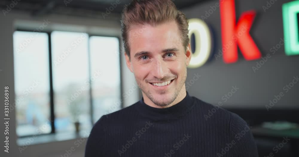 Smiling young businessman working at an office desk Smiling young businessman working at an office desk