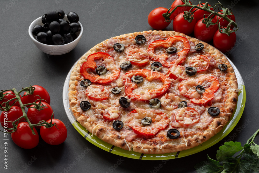 Pizza with olives, tomatoes, ham. Still-life. Assorted pizza