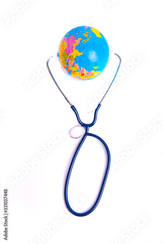 Coronavirus. Covid 19. Earth with mask and stethoscope on the white background.