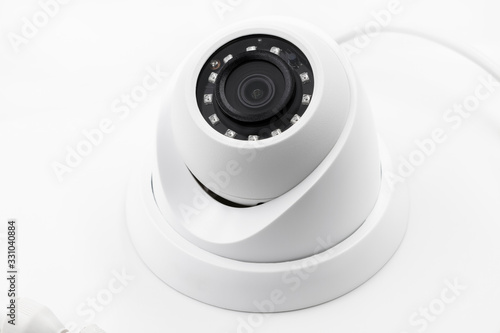 Dome secure camera on light background with motion sensors. Video surveillance camera. Closeup, selective focus