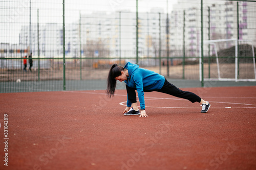 A young woman is engaged in sports on the Playground.