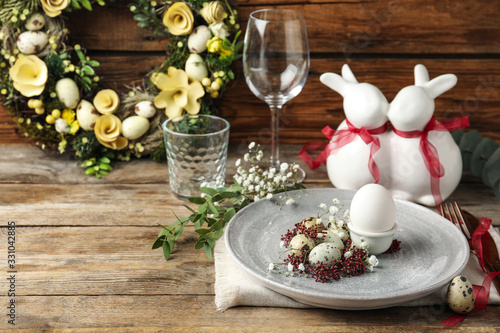 Festive Easter table setting with beautiful floral decor. Space for text