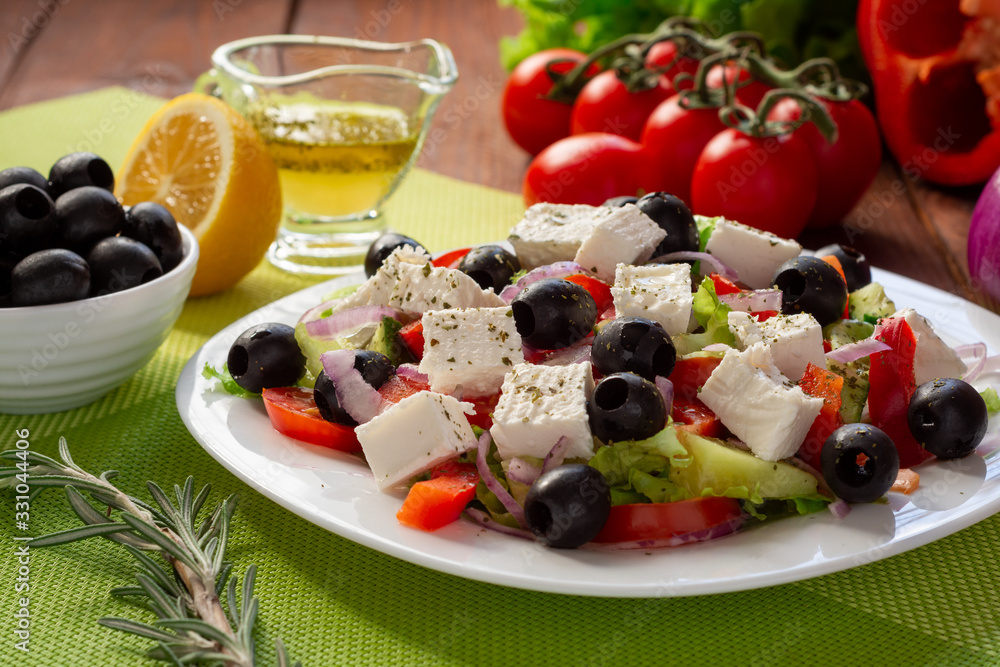 Greek salad with fresh cucumber , tomatoes, sweet pepper, lettuce, red onion, feta cheese and olives with olive oil. Healthy diet Greek salad with fresh cucumber , tomatoes, sweet pepper, lettuce, red onion, feta cheese and olives with olive oil. Healthy diet