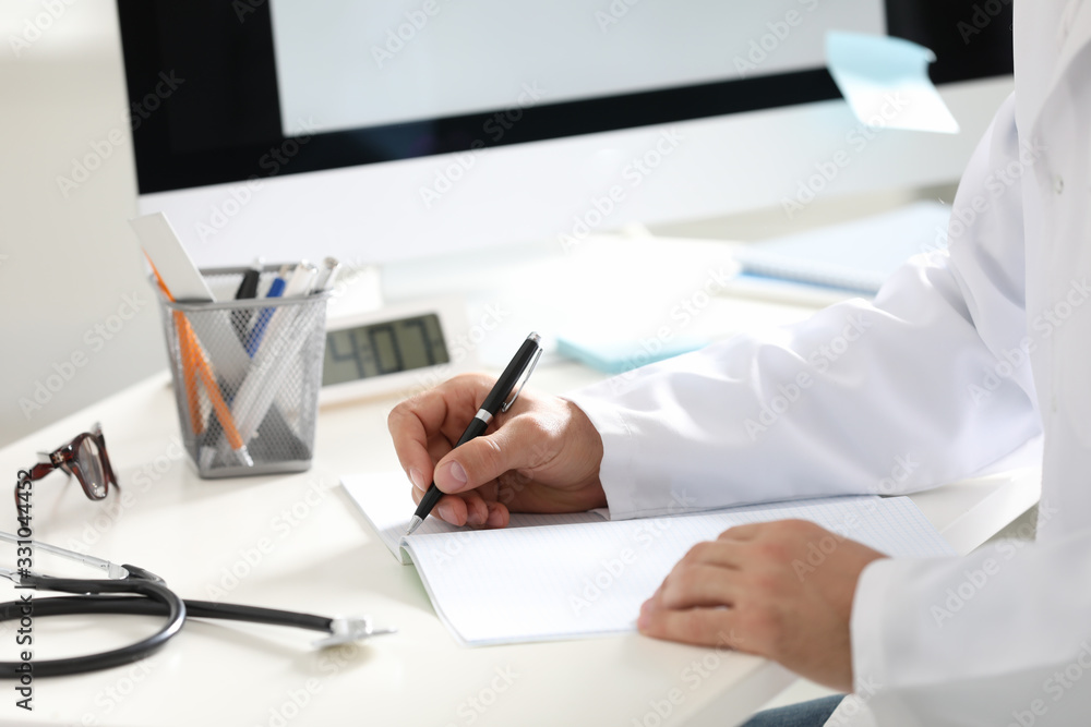Doctor working at desk in office, closeup Doctor working at desk in office, closeup