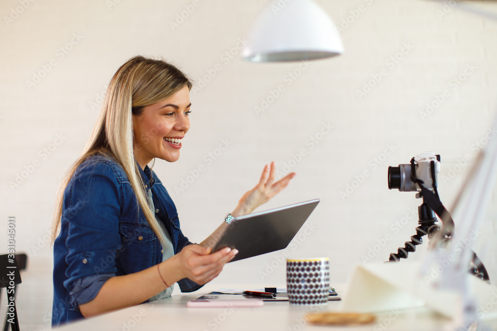 Young business woman recording video for her vlog and holding digital tablet Young business woman recording video for her vlog and holding digital tablet
