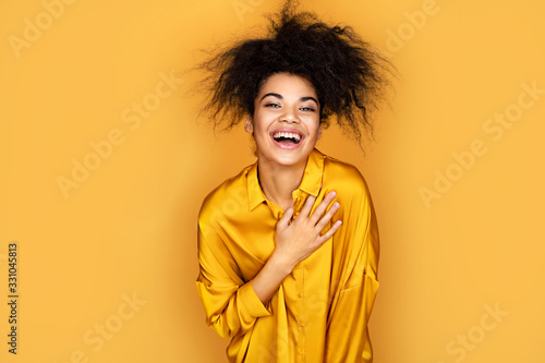 Fotografiet Overjoyed girl holds her hand on heart, can't stopping laughing