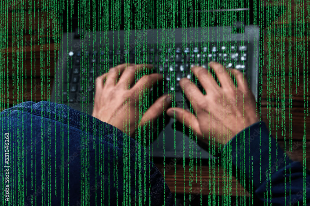Obraz premium Hacker with laptop and abstract binary code.