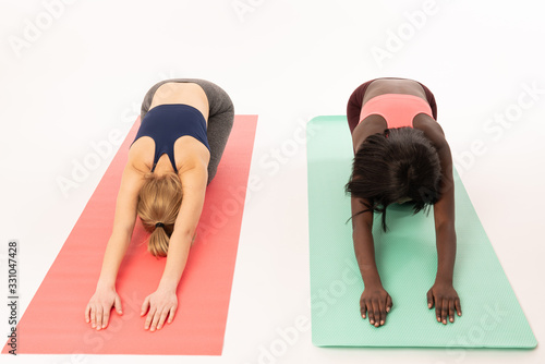 Stretching workout. A group of young international girls in sports uniforms are doing stretching training. Akroyoga, yoga, fitness, workout photo