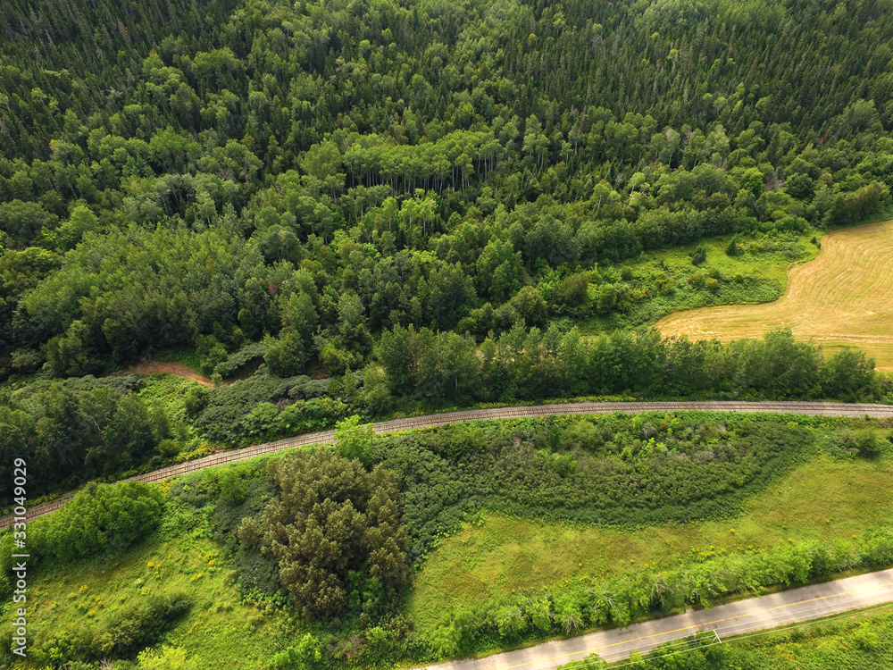 Aerial view of forested hill railway and road