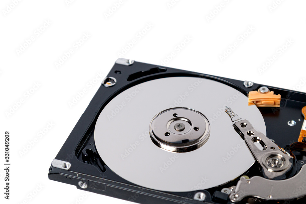 Disassembled hard drive from the computer on white background. Hdd pc repair service concept. Disassembled hard drive from the computer on white background. Hdd pc repair service concept.