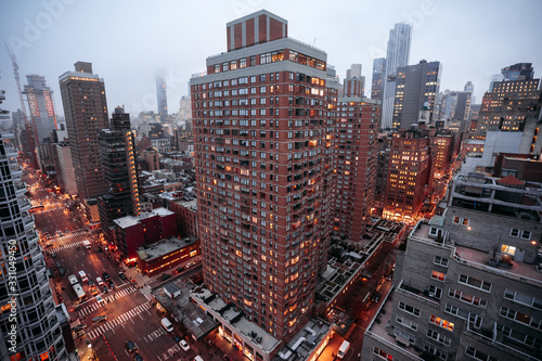 New York city skyline with foggy sky, night lights and traffic