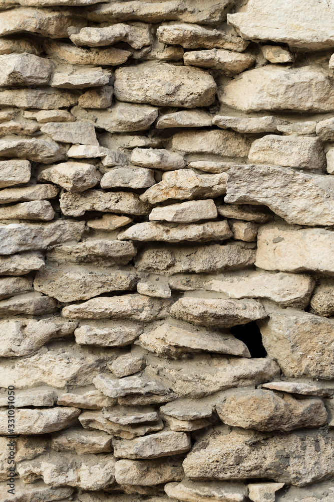 Background of limestone masonry. The surface is decorated with natural material. The wall is made of wild stone. Background of limestone masonry. The surface is decorated with natural material. The wall is made of wild stone.