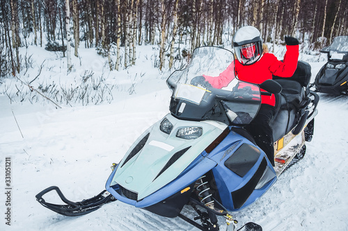 Woman in Snowmobile in Winter Finland Lapland at Christmas