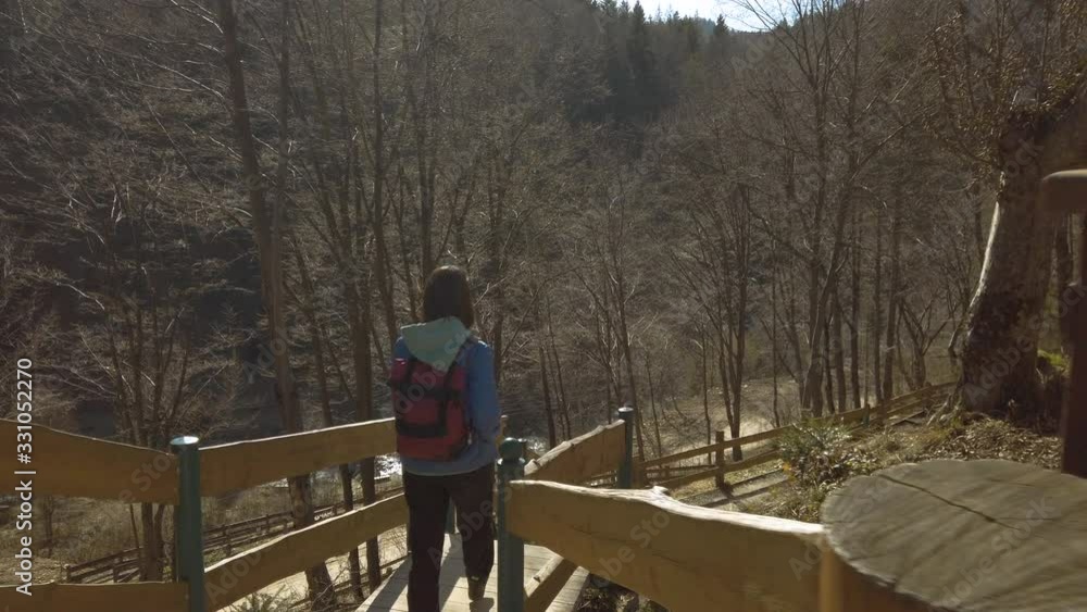 Female backpacker standing at the stairs on a mountain terrain with old film camera. Girl traveler enjoying of outdoor traveling. Recreating of life and self isolating. Female backpacker standing at the stairs on a mountain terrain with old film camera. Girl traveler enjoying of outdoor traveling. Recreating of life and self isolating.
