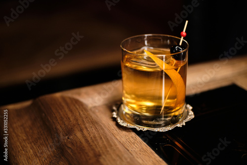 Perfect Old Fashioned cocktail with cherry and orange zest